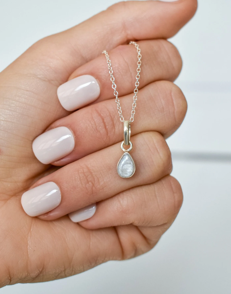 Silver cremation necklace with a teardrop pendant, designed as a simple memorial jewelry piece.