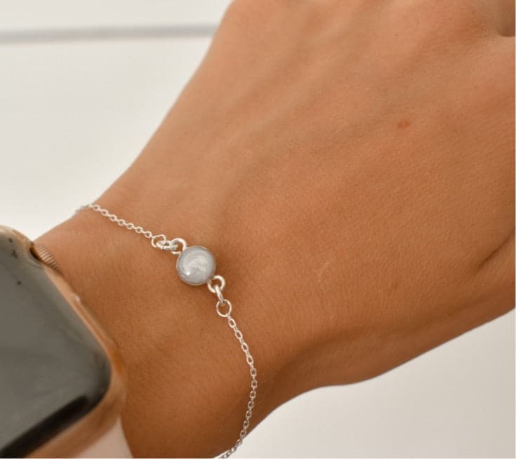 Sterling silver cremation bracelet with a small, round white gemstone, a simple memorial jewelry keepsake for a loved one or a pet