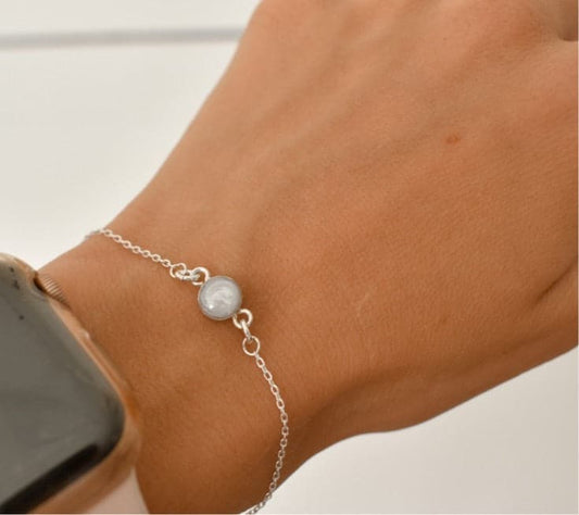 Sterling silver cremation bracelet with a small, round white gemstone, a simple memorial jewelry keepsake for a loved one or a pet